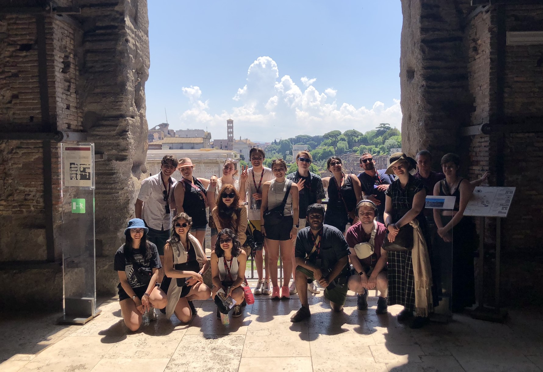 a group of students stands at a door in an ancient building