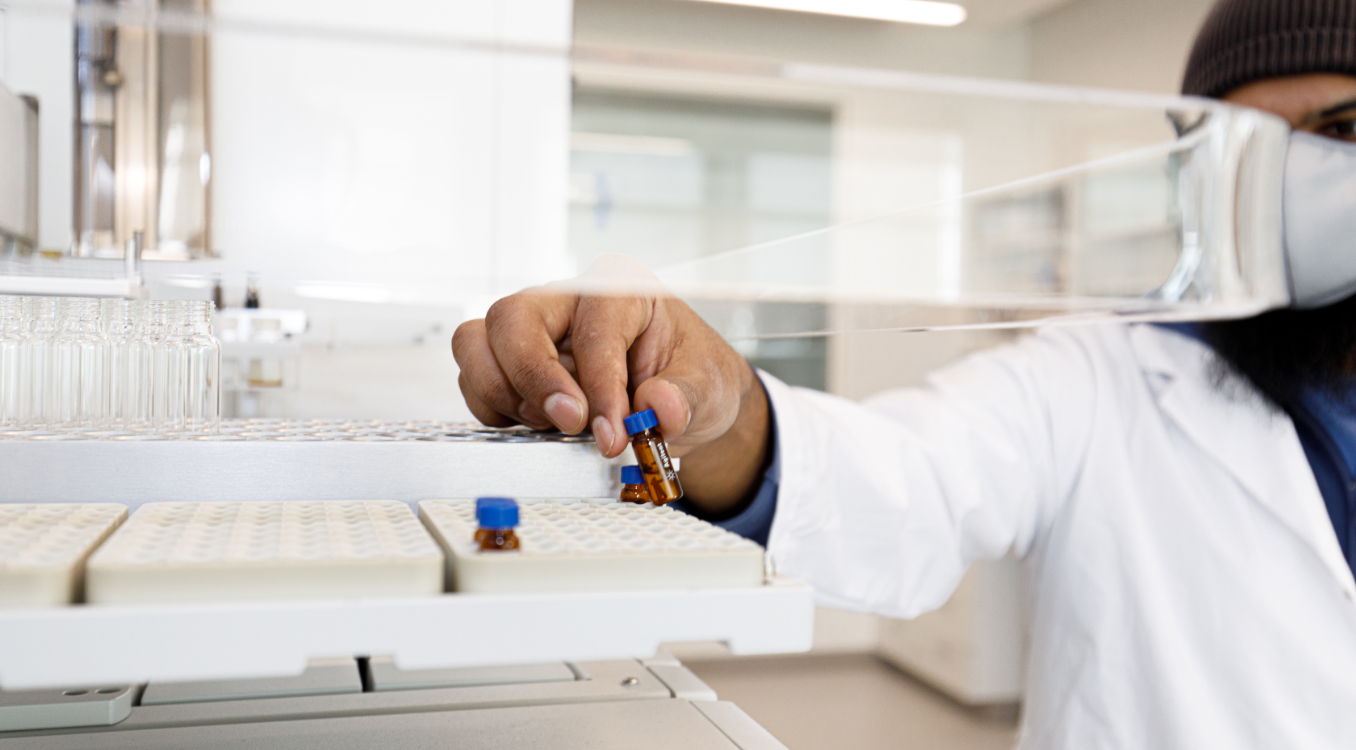 Chemistry student holding small glass vial