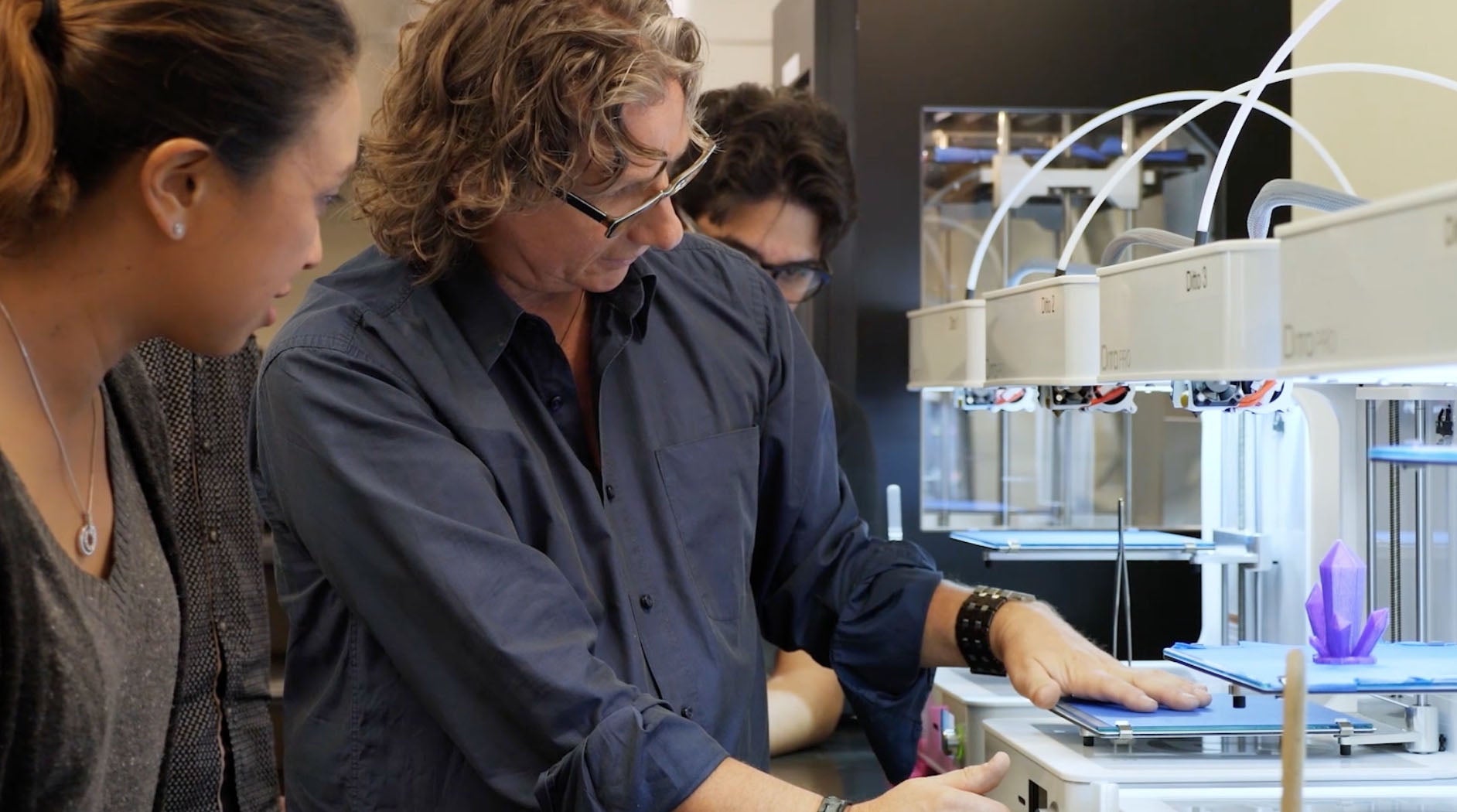 Instructor using a 3D printer