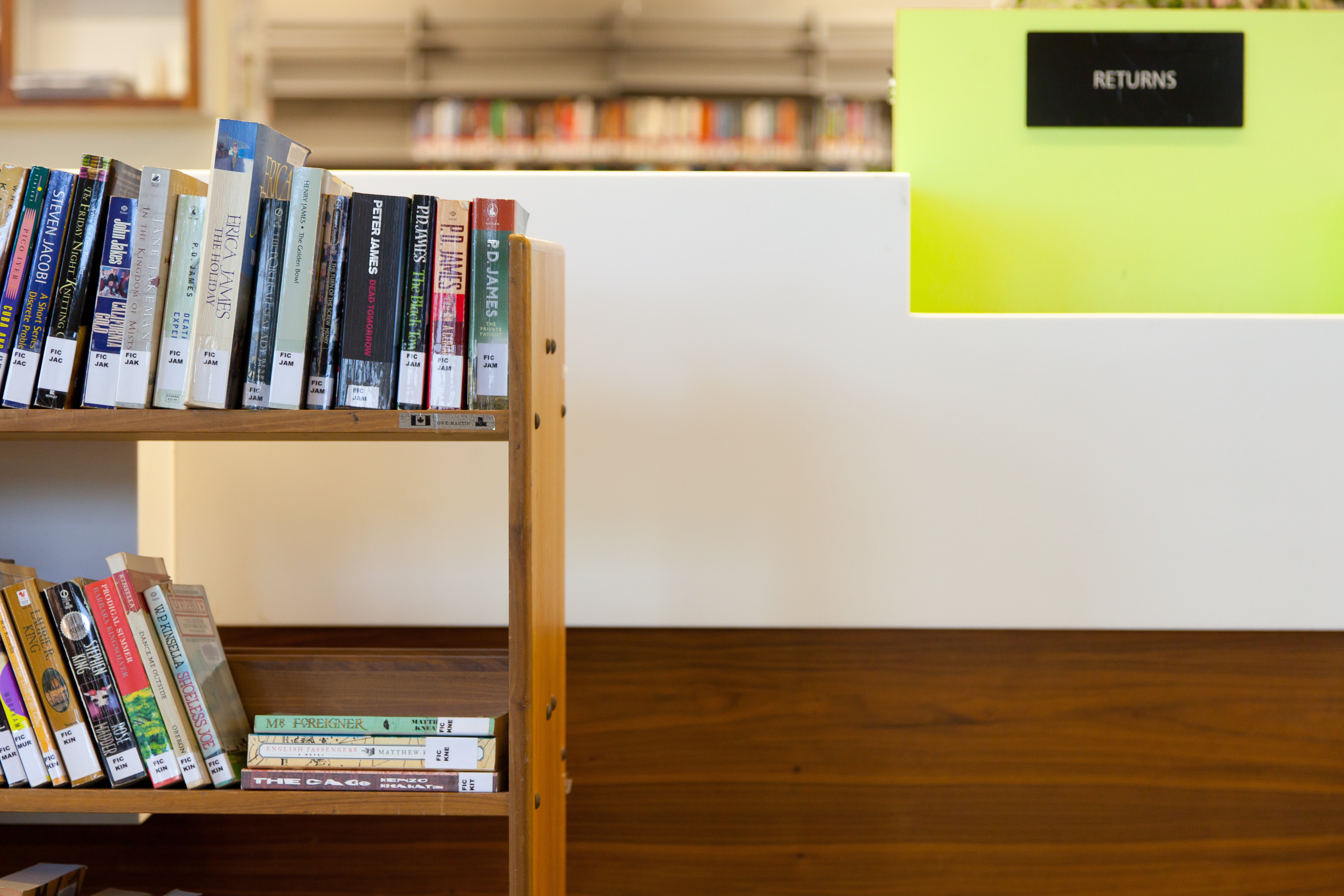 Library book cart in front of a book return sign
