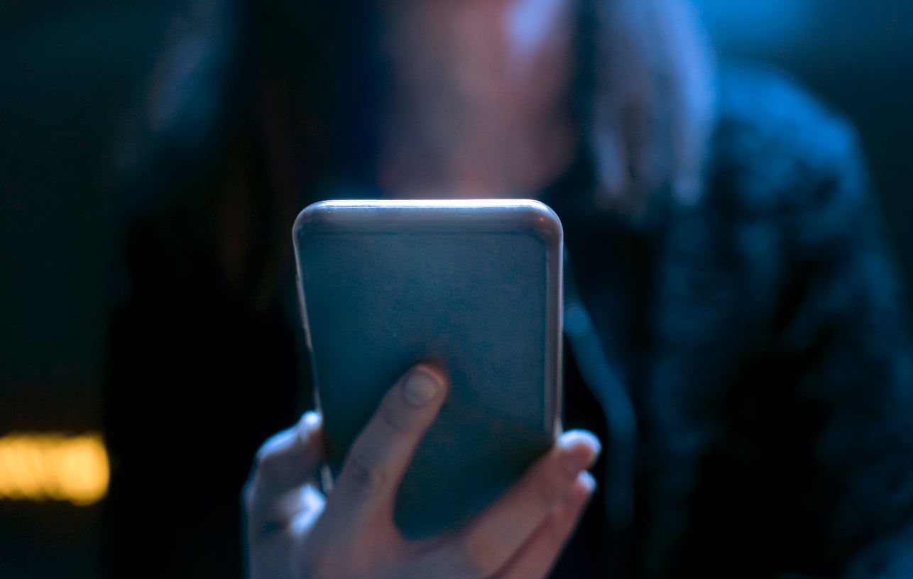 Person using a phone in the dark